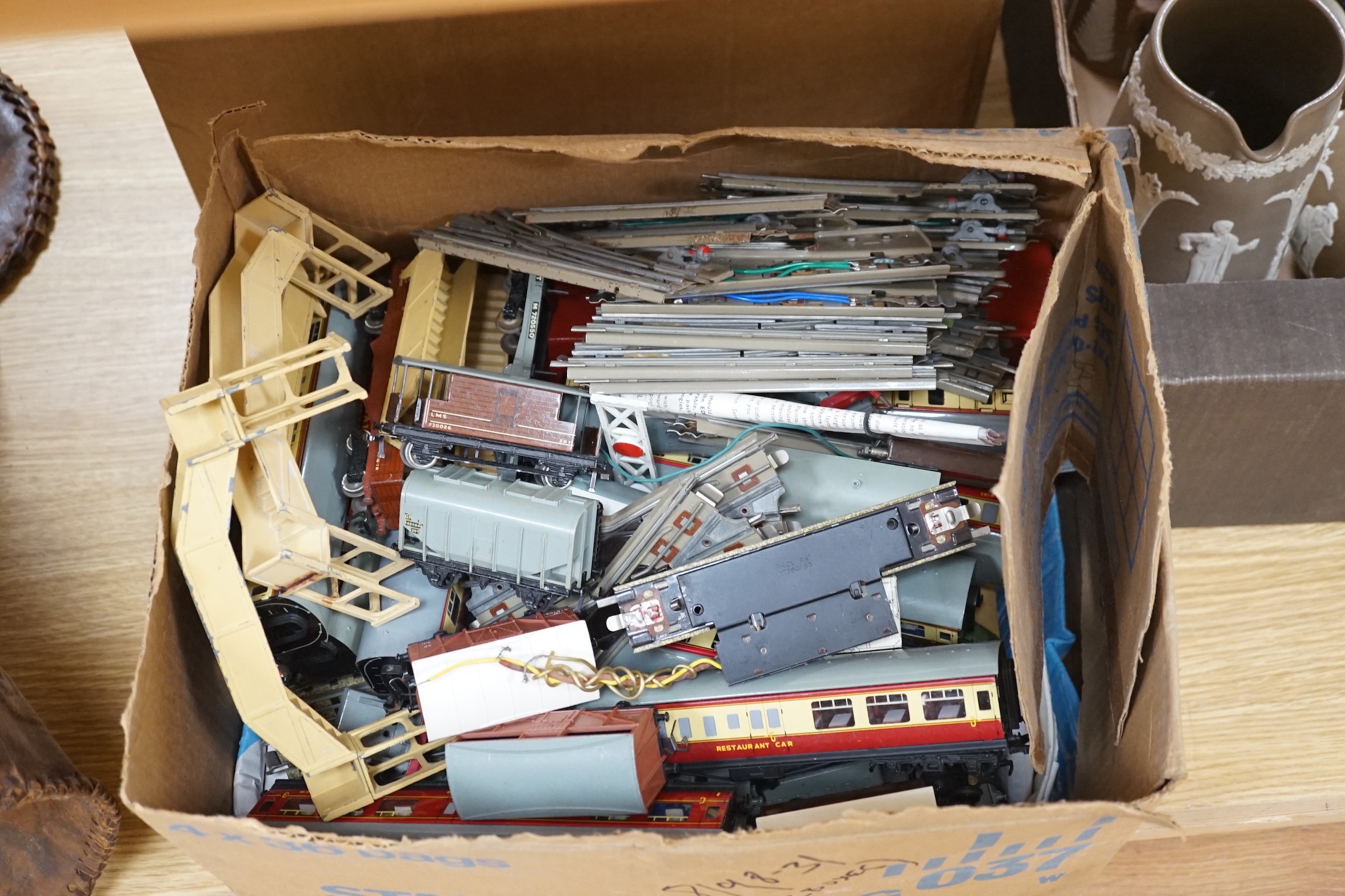 A Meccano Hornby tracks with its power board, trains, carriages, etc.